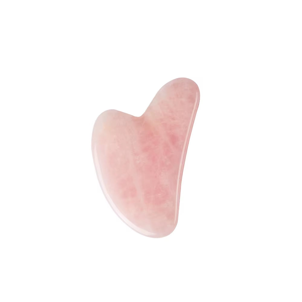 Rose quartz gua sha tool on a soft cream background — symbolizing The Reset, gentle skincare for sensitive skin