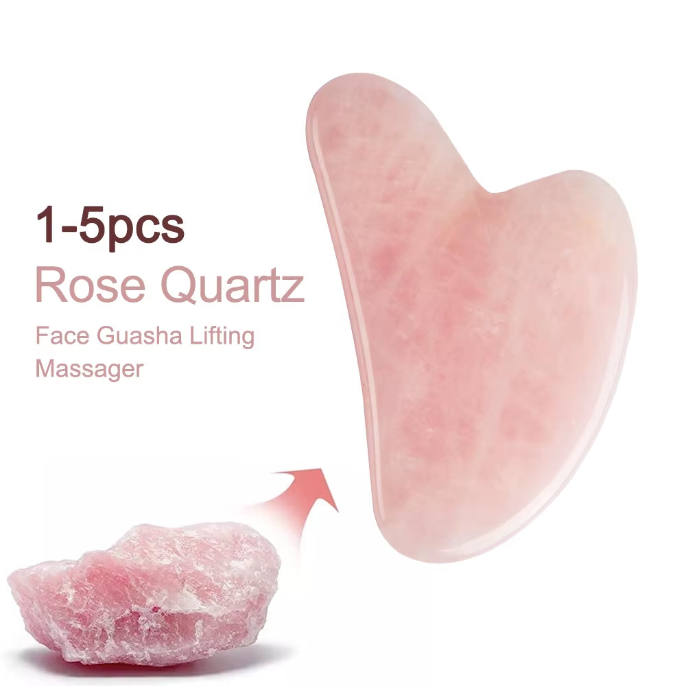 Rose quartz gua sha held against jawline