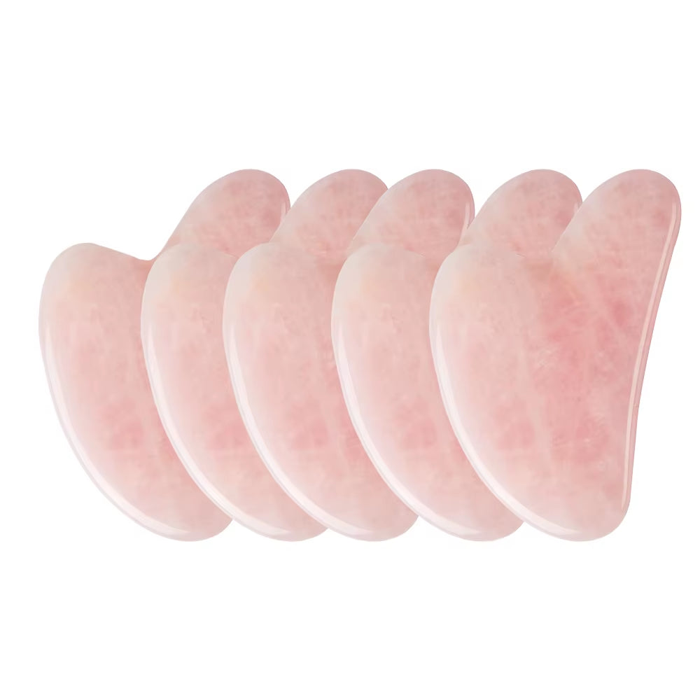 Rose quartz gua sha resting on linen